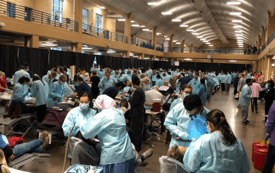 Dentists and dental team members treating patients at community event