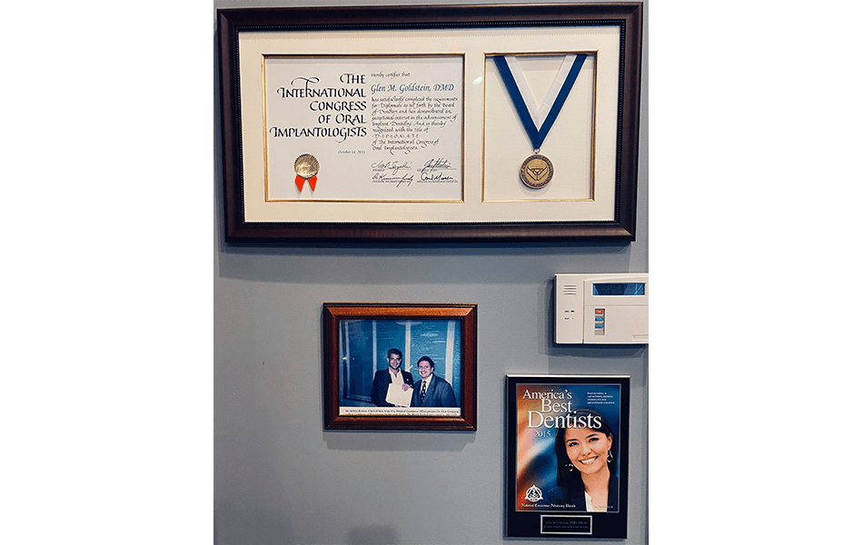 Awards and signs on dental office wall