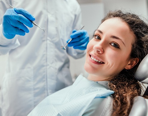 A female patient smiling in the dentist’s chair