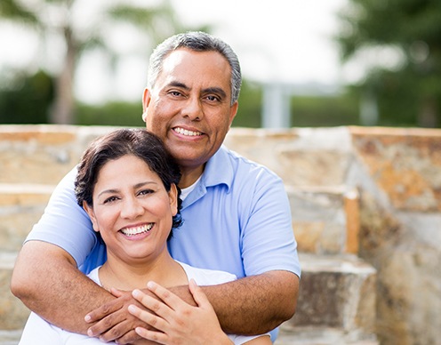 Man and woman smiling after Teeth tomorrow tooth replacement