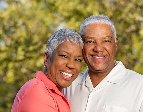 Smiling older man and woman after teeth tomorrow treatment