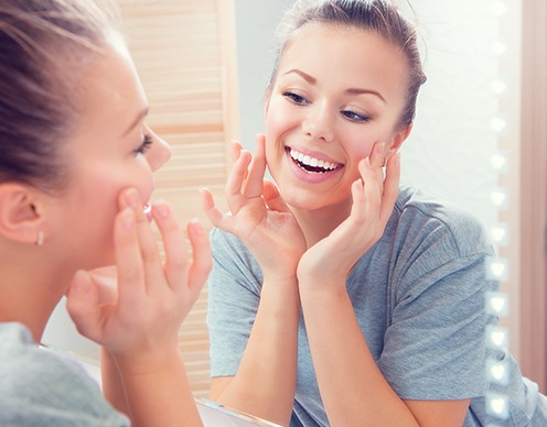 Woman looking at her skin after Botox treatment