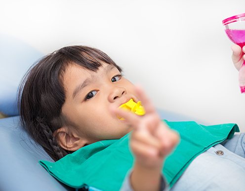 Child receiving fluoride treatment