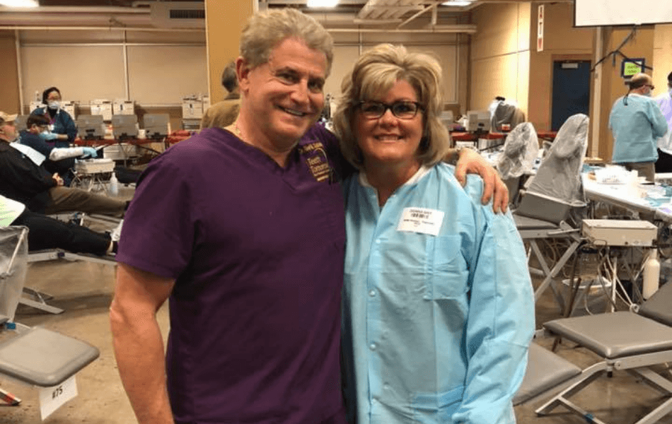 Doctor Goldstein and dental team member smiling together