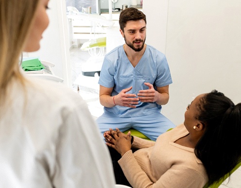 woman talking to cosmetic dentist in Randolph