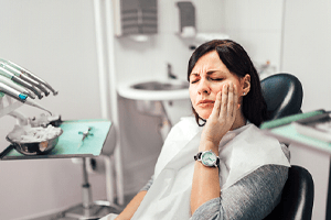 woman with dental emergency in Randolph