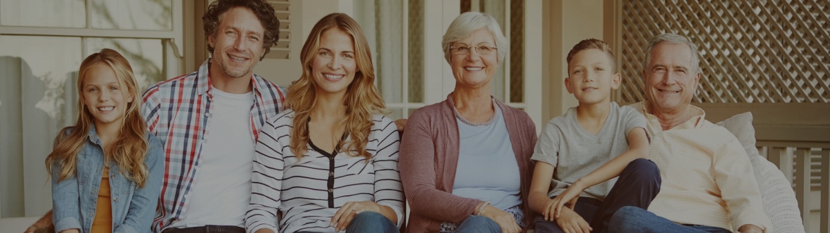 Three generations of family smiling together after family dentistry treatment