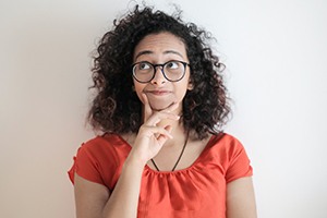 Thinking woman with her hand on her chin