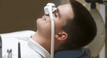 Man with nitrous oxide dental sedation mask in place
