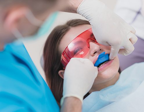 Woman smiling during fluoride treatment