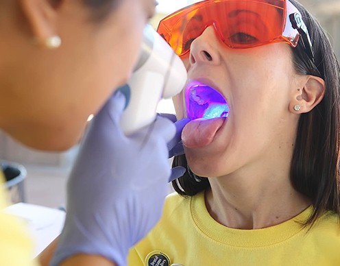 Woman receiving oral cancer screening