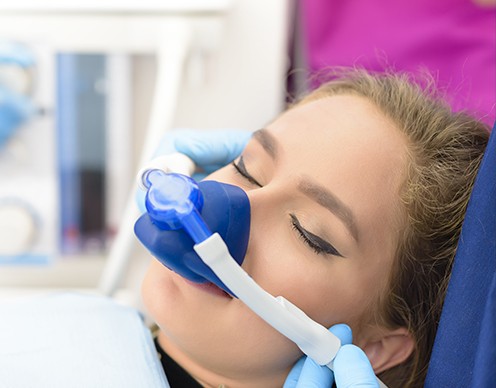 Woman with nitrous oxide dental sedation mask