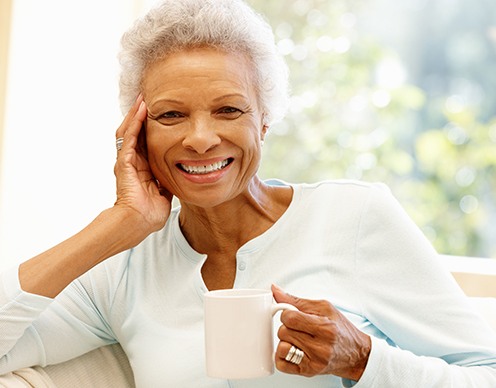 Woman smiling after T M J therapy with Doctor Goldstein