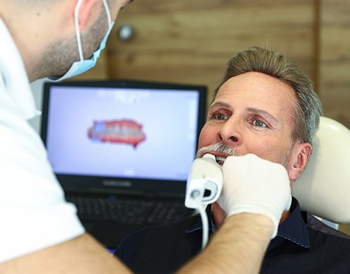 Dentist capturing bite impression with trios scanner