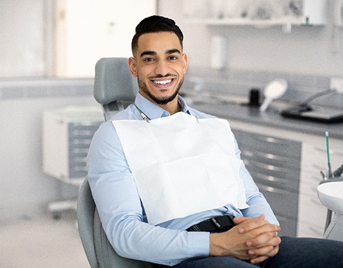 Patient smiling while sitting in treatment chair