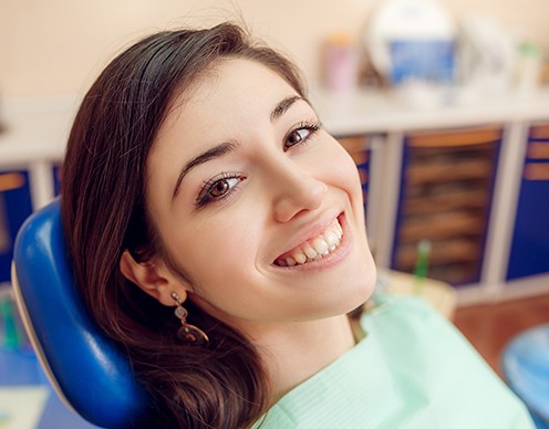 Woman smiling after wisdom tooth extraction