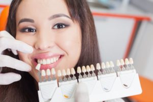 woman posing beside porcelain veneers