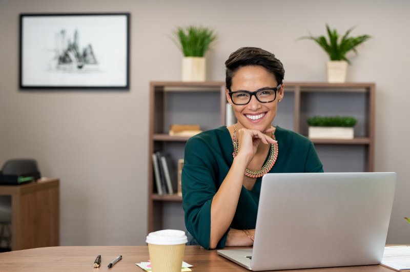 Business woman smiling at her desk