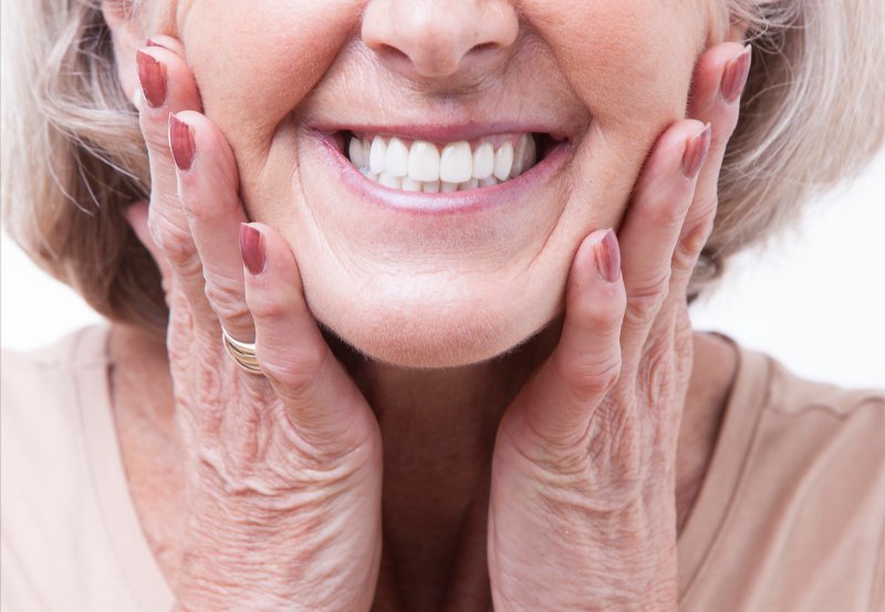 Close-up view of smiling senior woman’s dentures